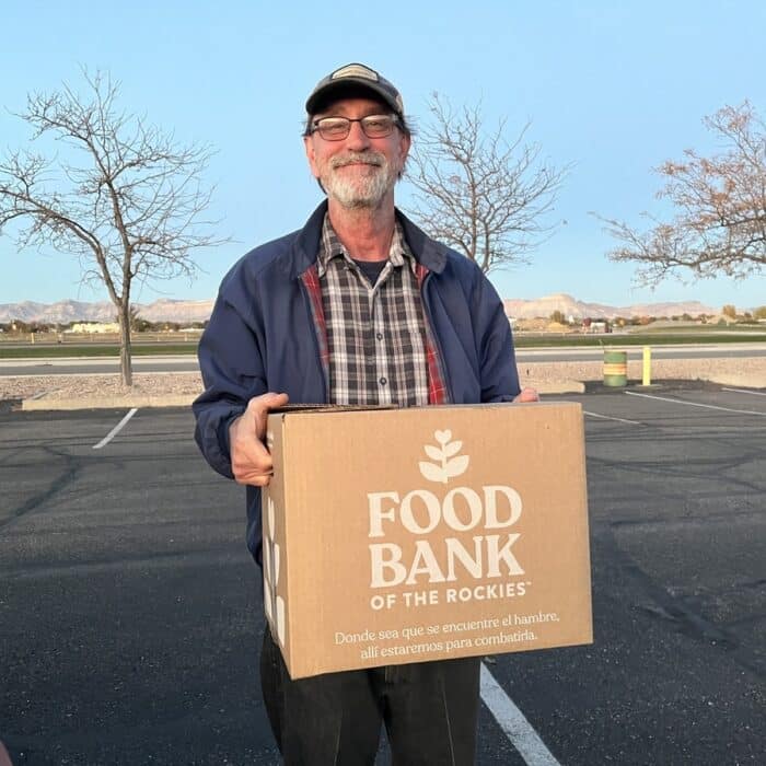 man holding a box of food