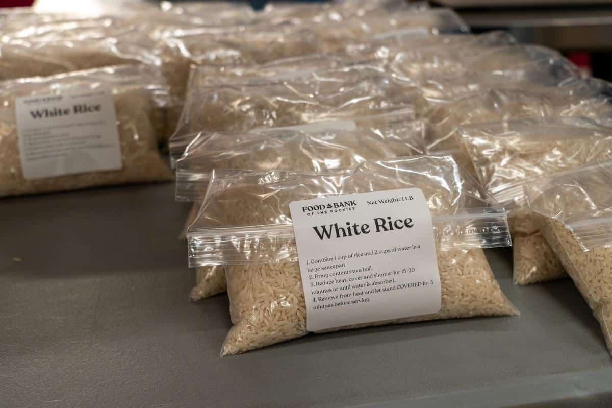 Bags of white rice, an example of staples to stock up on to create easy healthy meals on a budget.