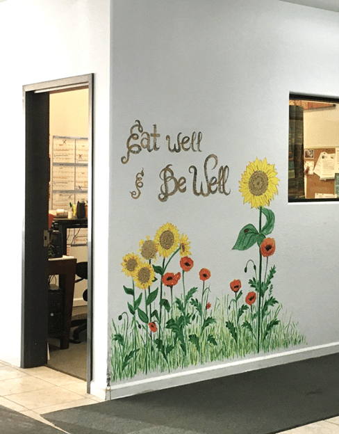 Eat Well, Be Well mural on the side of a building