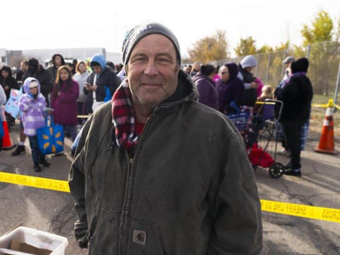 a man standing outside wearing a winter hat and coat