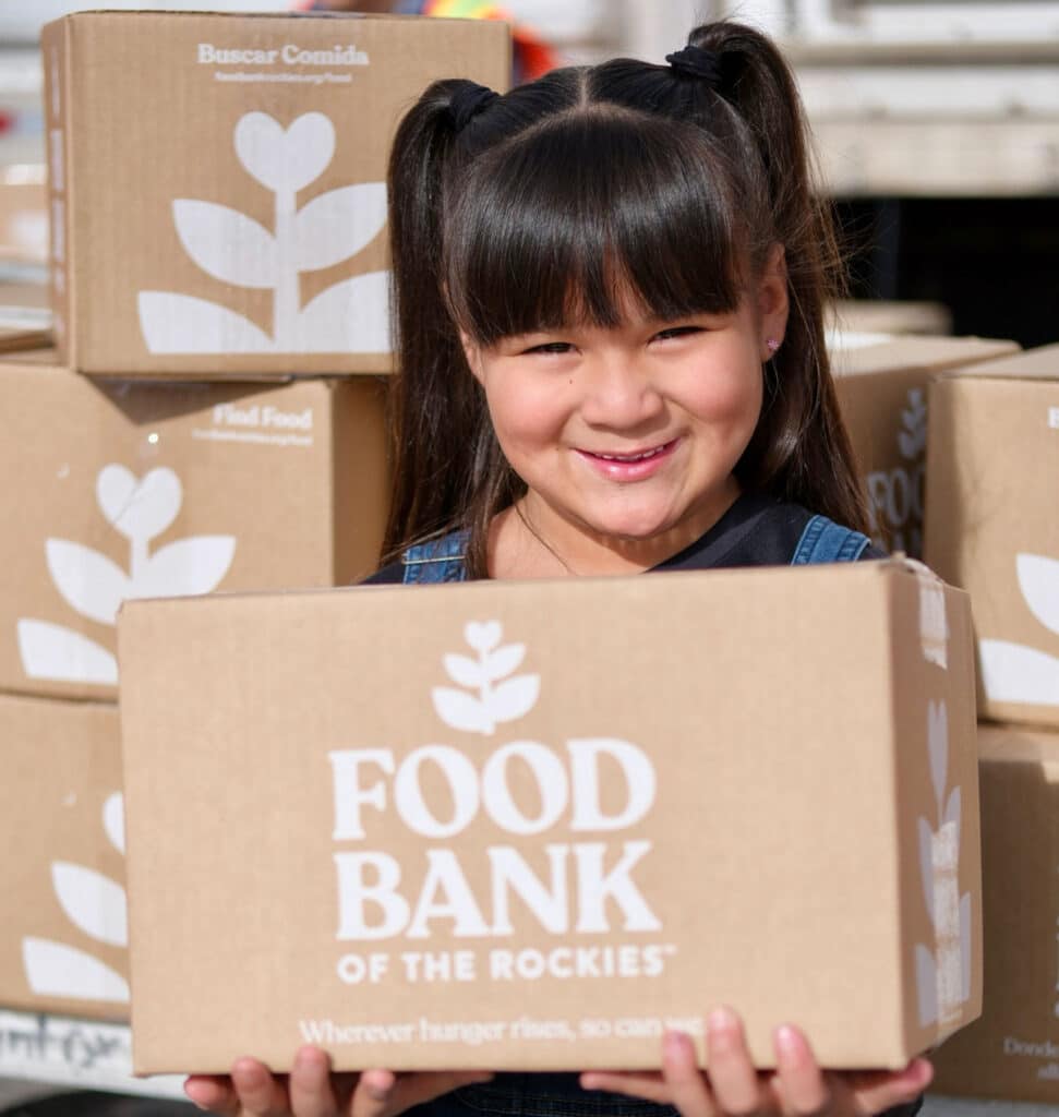 a girl holding a box of food