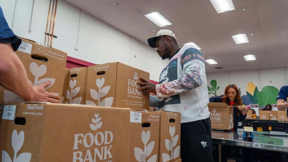Broncos player stacking boxes.