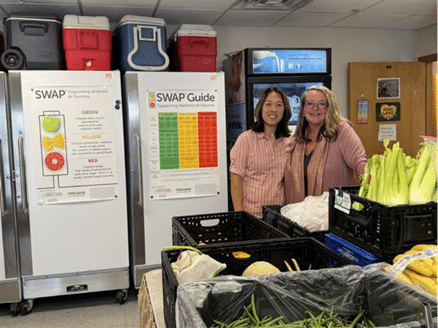 Jennie Kim, MPH, RDN (Nutrition Manager) with Shellie McKeown, Community Health Manager, at Mountain Resource Center’s food pantry