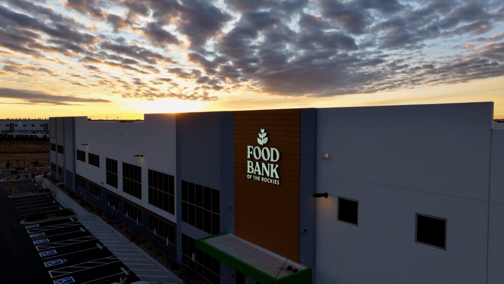 New food bank of the rockies distribution center shot with a drone, sunrise in the background.