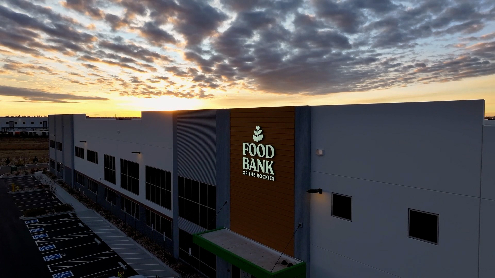 New food bank of the rockies distribution center shot with a drone, sunrise in the background.
