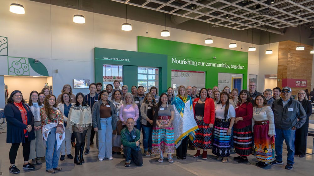 Large group of staff posing in the lobby of the new distribution center.