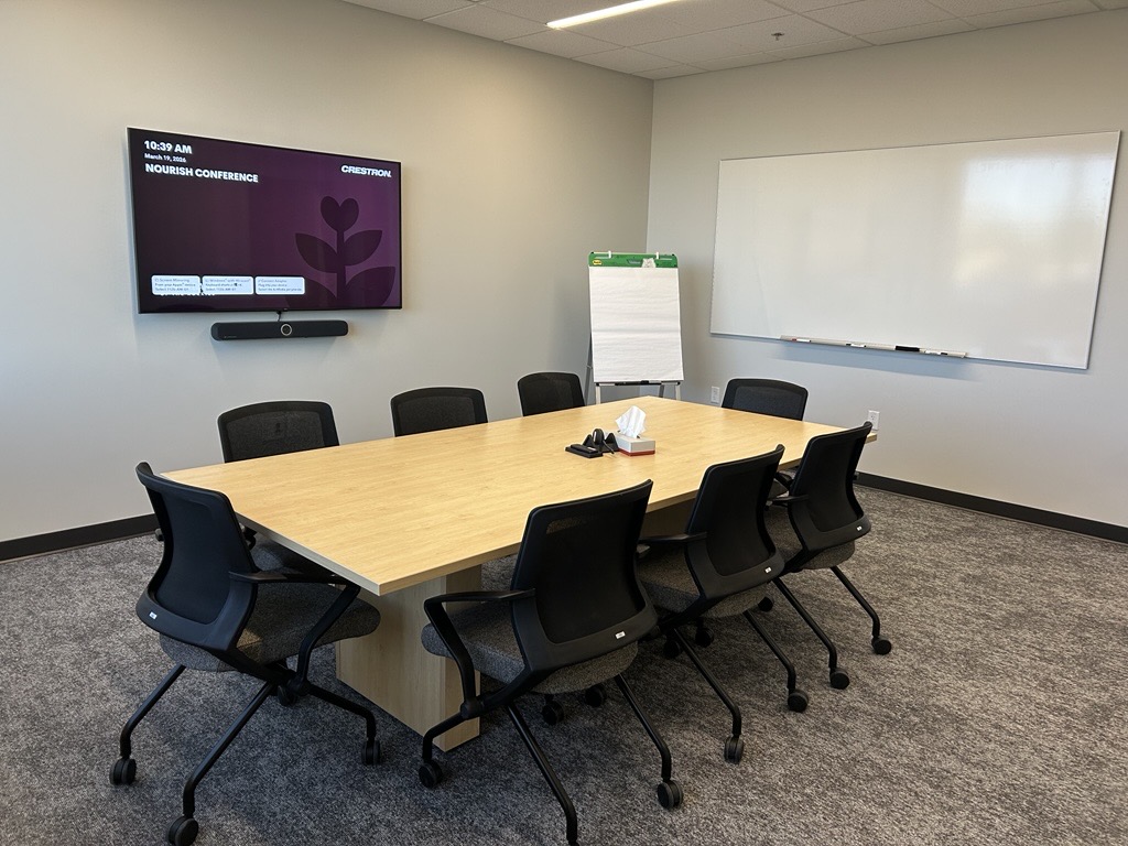 Table and chairs in a small meeting room.