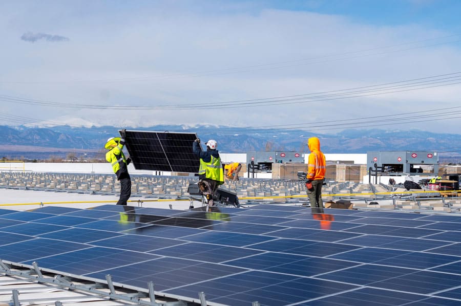 solar panels being installed on the Food Bank of the Rockies' distribution center roof.