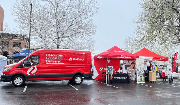 xcel trucks and tents at an outside event