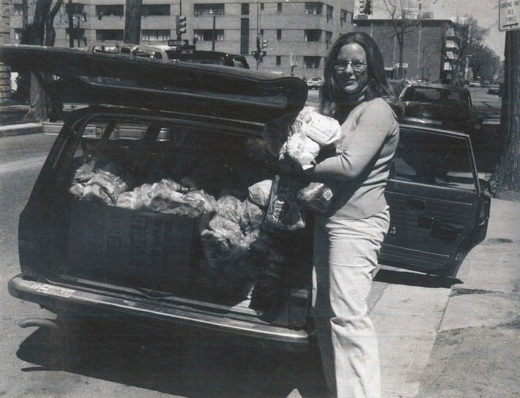 The trunk of a Volvo filled with rescued bread.