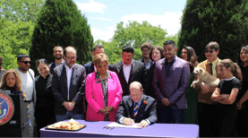 Governor Polis with group of people behind him.
