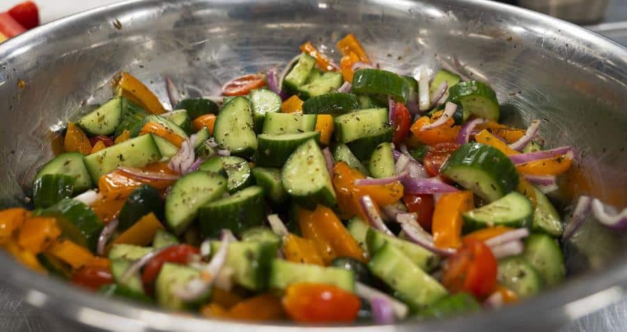Zucchini salad in a stainless steel bowl.